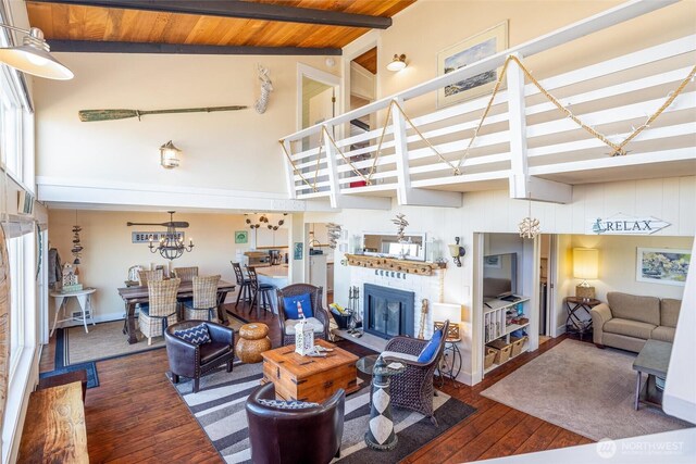 4421 Sucia Dr, Ferndale, WA 98248 - living room featuring high vaulted ceiling, hardwood / wood-style flooring, a fireplace, a wood ceiling with exposed beams, and a chandelier