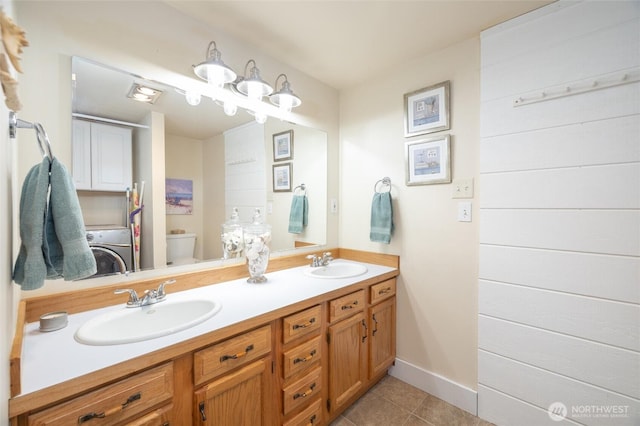 4421 Sucia Dr, Ferndale, WA 98248 - bathroom featuring washer / clothes dryer, double vanity, and tile patterned floors