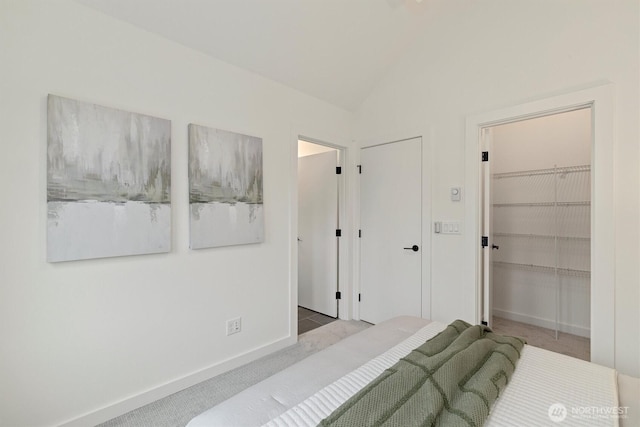 1323 N 185th St Unit A, Shoreline, WA 98133 - carpeted bedroom featuring a spacious closet and vaulted ceiling