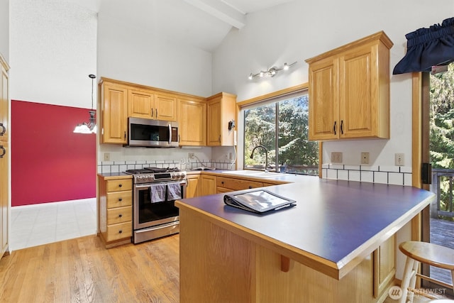 2417 179th Ave E, Lake Tapps, WA 98391 - kitchen with stainless steel appliances, beamed ceiling, a peninsula, light wood-style flooring, and high vaulted ceiling