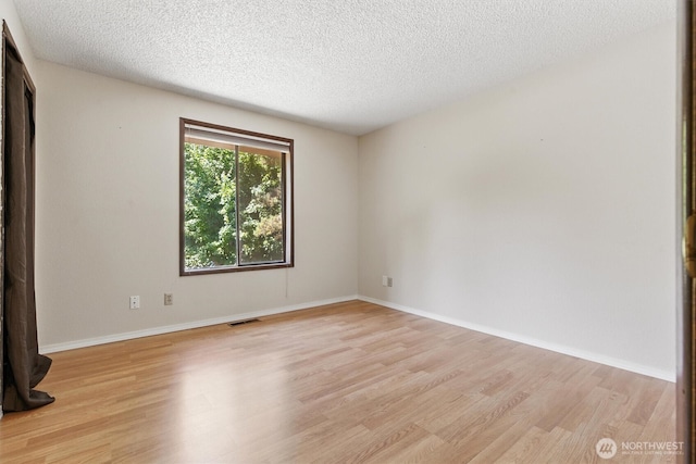 2417 179th Ave E, Lake Tapps, WA 98391 - spare room with light wood finished floors and a textured ceiling