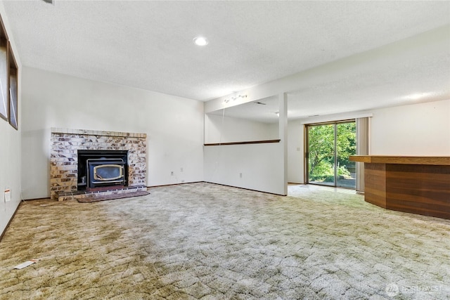 2417 179th Ave E, Lake Tapps, WA 98391 - unfurnished living room featuring carpet floors, a wood stove, a textured ceiling, and recessed lighting