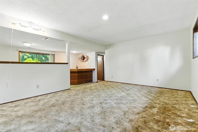 2417 179th Ave E, Lake Tapps, WA 98391 - empty room featuring carpet flooring, a textured ceiling, and bar area