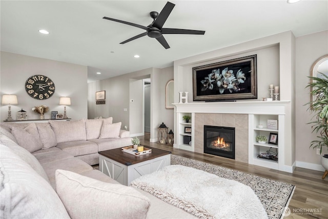 1118 26th St NW, Puyallup, WA 98373 - living area with ceiling fan, wood finished floors, recessed lighting, a tile fireplace, and built in features