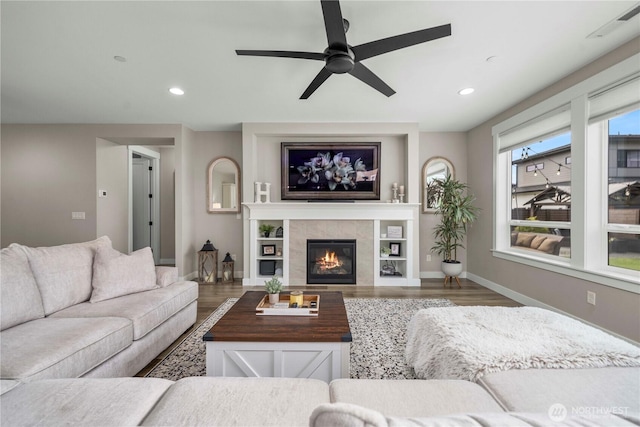 1118 26th St NW, Puyallup, WA 98373 - living area with a ceiling fan, wood finished floors, a tiled fireplace, and recessed lighting