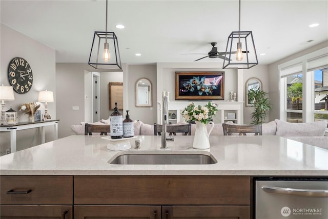 1118 26th St NW, Puyallup, WA 98373 - kitchen with stainless steel dishwasher, open floor plan, a ceiling fan, light stone counters, and recessed lighting