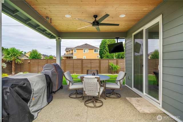 1118 26th St NW, Puyallup, WA 98373 - fenced backyard with outdoor dining area, a patio, a grill, and a ceiling fan