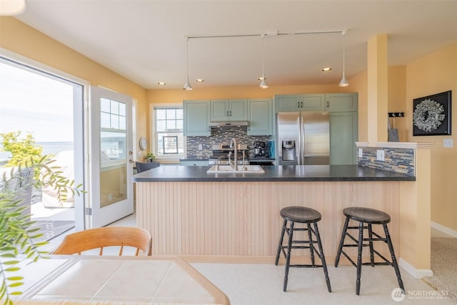 618 12th St, Bellingham, WA 98225 - kitchen featuring stainless steel fridge, tasteful backsplash, dark countertops, and recessed lighting