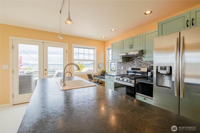 618 12th St, Bellingham, WA 98225 - kitchen with stainless steel appliances, green cabinetry, under cabinet range hood, dark countertops, and french doors