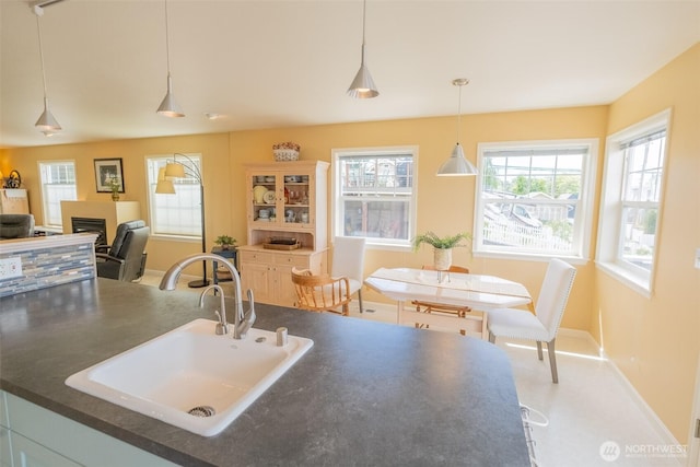 618 12th St, Bellingham, WA 98225 - kitchen featuring dark countertops, healthy amount of natural light, a fireplace, and pendant lighting