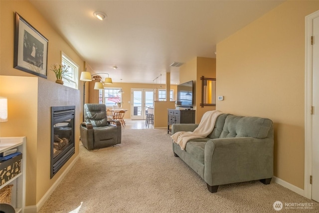 618 12th St, Bellingham, WA 98225 - carpeted living area featuring a glass covered fireplace and plenty of natural light