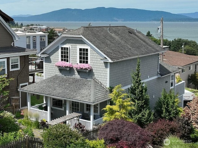618 12th St, Bellingham, WA 98225 - back of property with a mountain view, a shingled roof, and a porch