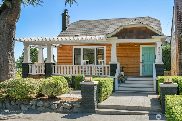 2456 4th Ave W, Seattle, WA 98119 - view of front of home featuring a porch and a chimney