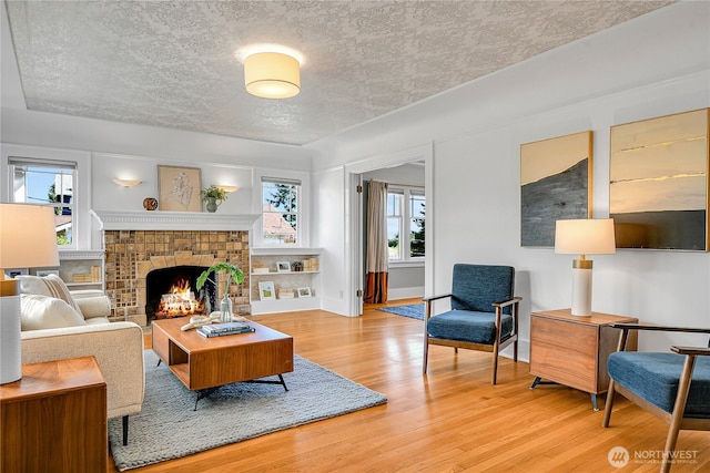 2456 4th Ave W, Seattle, WA 98119 - living room with wood finished floors, a brick fireplace, and a textured ceiling