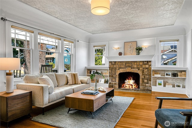 2456 4th Ave W, Seattle, WA 98119 - living room featuring wood finished floors and a lit fireplace