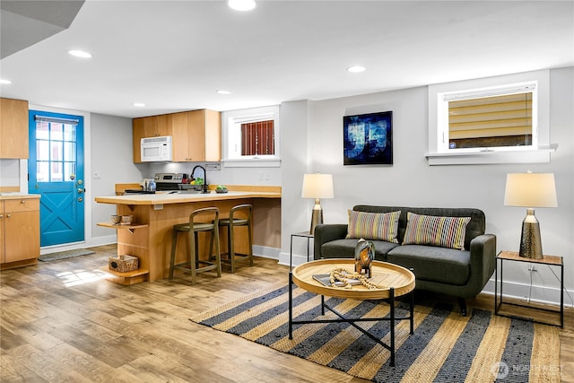 2456 4th Ave W, Seattle, WA 98119 - living room with recessed lighting and light wood-style flooring