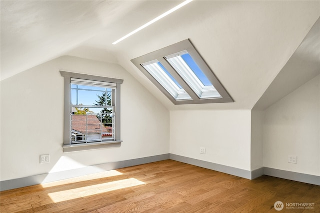 2456 4th Ave W, Seattle, WA 98119 - additional living space with a skylight, lofted ceiling, and wood finished floors