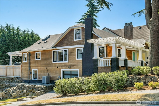 2456 4th Ave W, Seattle, WA 98119 - view of property exterior featuring a chimney, a porch, and a shingled roof