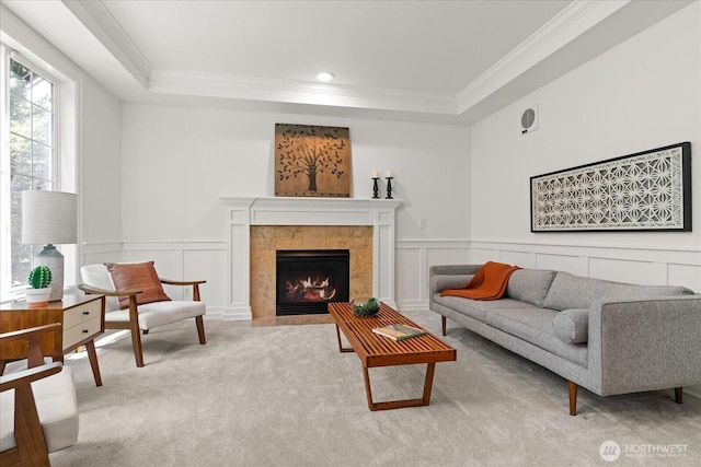 19735 183rd Way SE, Renton, WA 98058 - carpeted living room featuring crown molding, a raised ceiling, a tiled fireplace, a decorative wall, and wainscoting