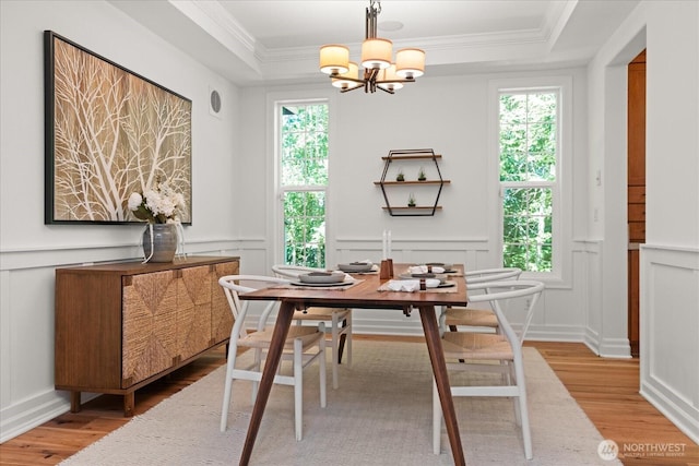 19735 183rd Way SE, Renton, WA 98058 - dining area featuring a decorative wall, light wood-style floors, a chandelier, a raised ceiling, and ornamental molding