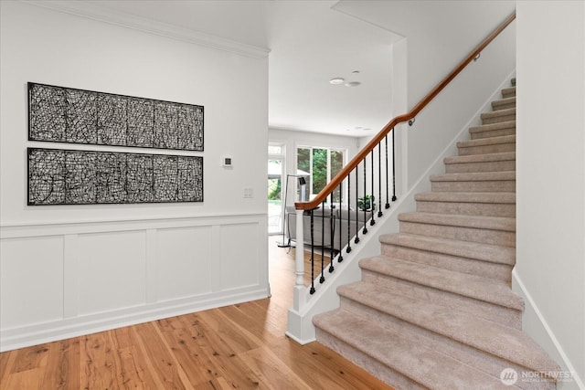 19735 183rd Way SE, Renton, WA 98058 - stairs featuring wood finished floors, a wainscoted wall, a decorative wall, and recessed lighting