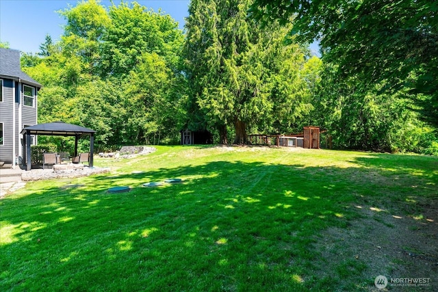 19735 183rd Way SE, Renton, WA 98058 - view of green lawn featuring a gazebo, a storage shed, and a patio area