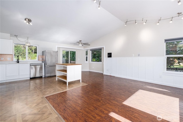 120 E Rd Of Tralee, Shelton, WA 98584 - living area featuring track lighting, plenty of natural light, a wainscoted wall, a ceiling fan, and lofted ceiling