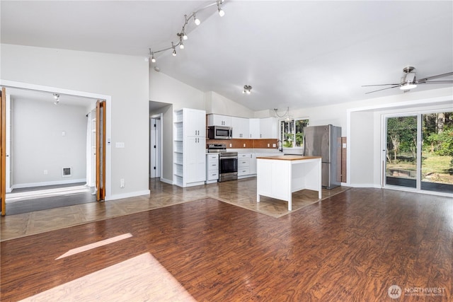 120 E Rd Of Tralee, Shelton, WA 98584 - kitchen featuring lofted ceiling, open floor plan, appliances with stainless steel finishes, white cabinetry, and a center island