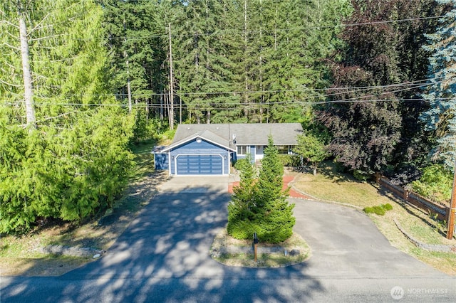 120 E Rd Of Tralee, Shelton, WA 98584 - view of front of home featuring asphalt driveway, an attached garage, and a view of trees