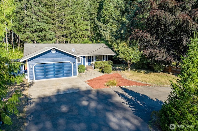120 E Rd Of Tralee, Shelton, WA 98584 - ranch-style home with concrete driveway, a garage, a porch, and a forest view