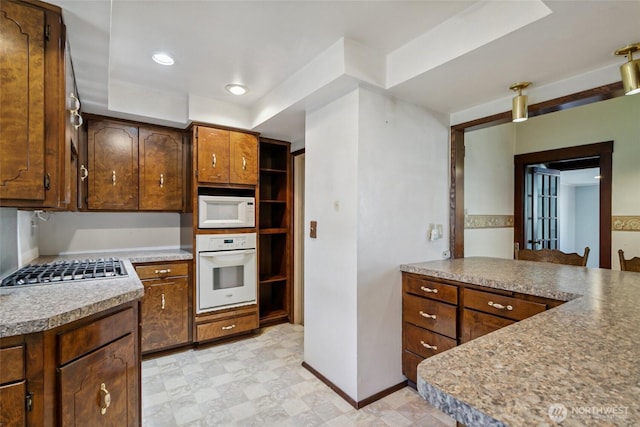 511 N Iron St, Centralia, WA 98531 - kitchen featuring white appliances, light floors, a raised ceiling, light countertops, and recessed lighting