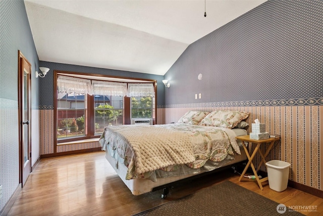 511 N Iron St, Centralia, WA 98531 - bedroom with wallpapered walls, lofted ceiling, wood finished floors, and wainscoting