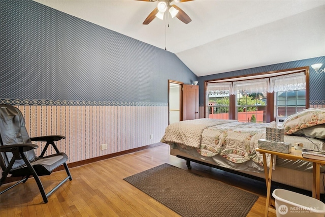 511 N Iron St, Centralia, WA 98531 - bedroom featuring wallpapered walls, vaulted ceiling, wood finished floors, and ceiling fan