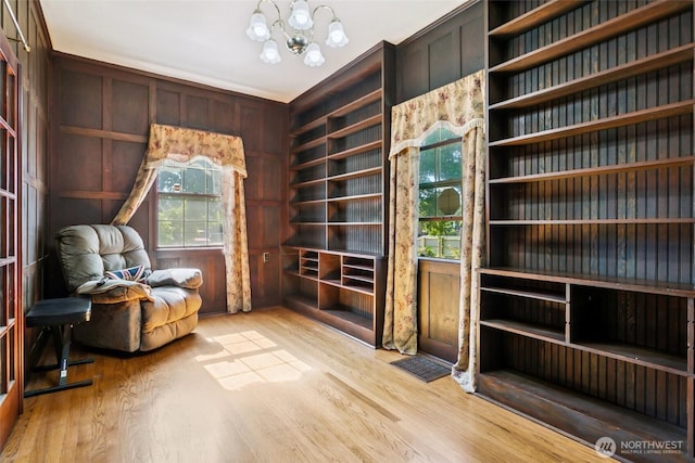 511 N Iron St, Centralia, WA 98531 - sitting room featuring wood finished floors, a chandelier, and wooden walls