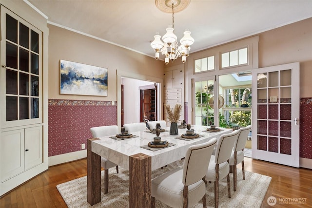 511 N Iron St, Centralia, WA 98531 - dining area featuring a chandelier, ornamental molding, wood finished floors, and wallpapered walls