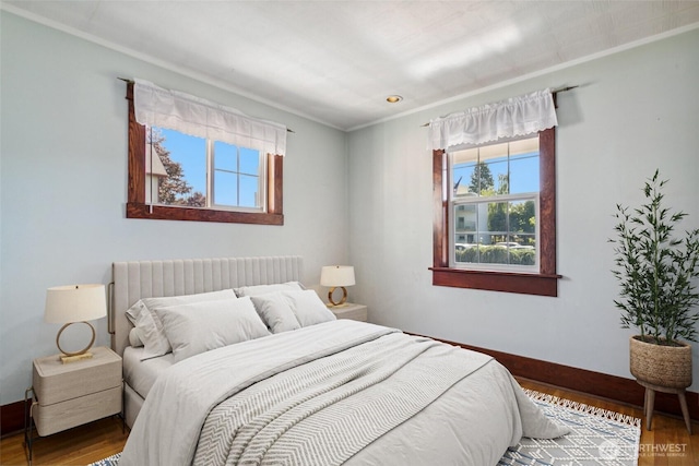 511 N Iron St, Centralia, WA 98531 - bedroom featuring multiple windows, crown molding, radiator heating unit, and wood finished floors
