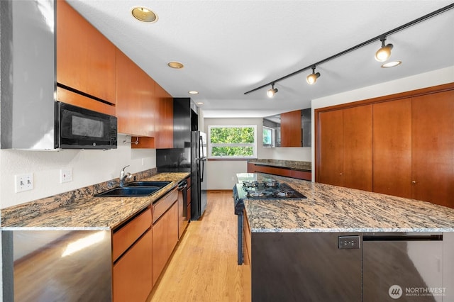 5225 Illahee Ln NE, Olympia, WA 98516 - kitchen featuring black microwave, freestanding refrigerator, light wood-type flooring, range with gas cooktop, and a kitchen island