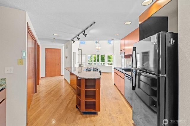 5225 Illahee Ln NE, Olympia, WA 98516 - kitchen featuring freestanding refrigerator, stainless steel dishwasher, light wood-type flooring, and rail lighting