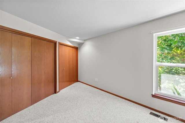 5225 Illahee Ln NE, Olympia, WA 98516 - unfurnished bedroom featuring carpet floors and two closets