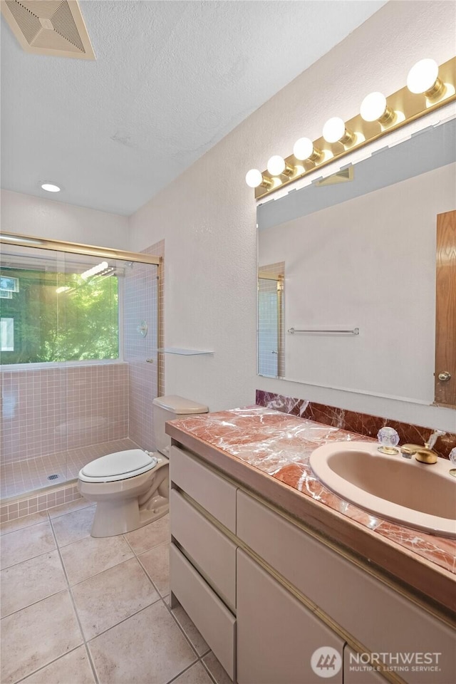 5225 Illahee Ln NE, Olympia, WA 98516 - full bath with tile patterned flooring, a stall shower, vanity, and a textured ceiling