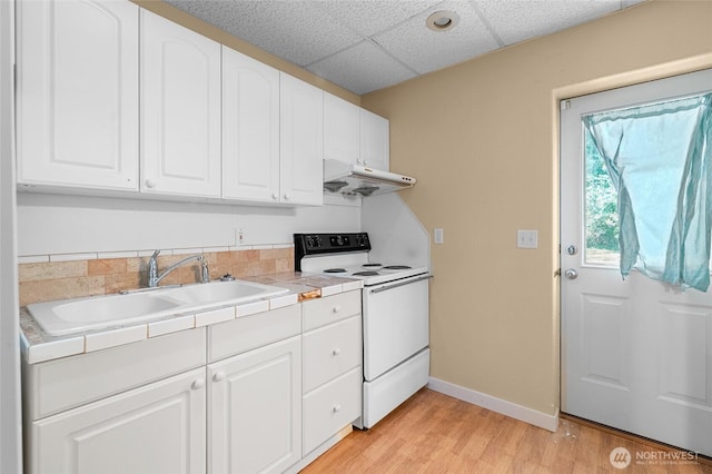 5225 Illahee Ln NE, Olympia, WA 98516 - kitchen with white electric range oven, under cabinet range hood, tile counters, white cabinetry, and light wood-style flooring