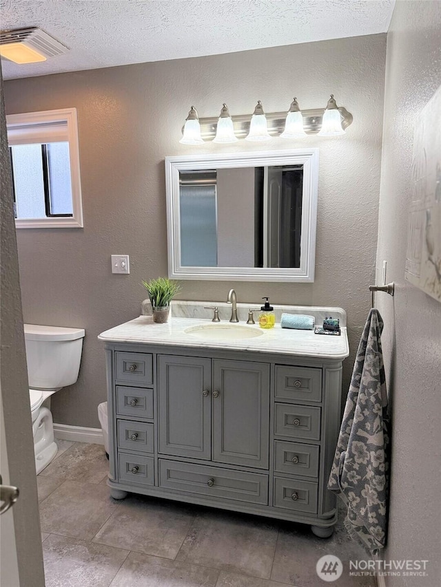 598 Blue Wing Loop SE, Ocean Shores, WA 98569 - bathroom featuring vanity, tile patterned floors, and a textured ceiling