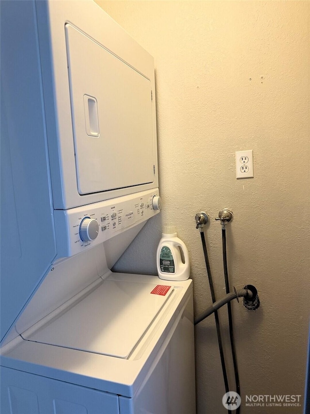 598 Blue Wing Loop SE, Ocean Shores, WA 98569 - washroom featuring stacked washer / dryer and a textured wall
