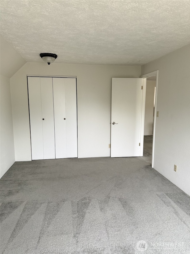 598 Blue Wing Loop SE, Ocean Shores, WA 98569 - unfurnished bedroom with carpet flooring, a textured ceiling, and a closet