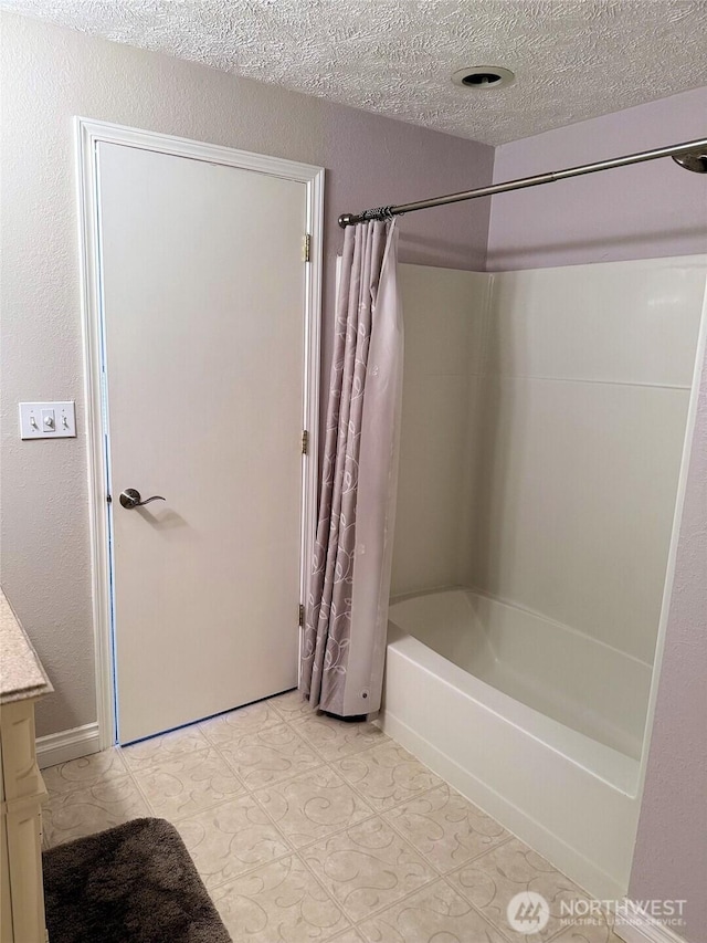 598 Blue Wing Loop SE, Ocean Shores, WA 98569 - bathroom with shower / bathtub combination with curtain, vanity, and a textured ceiling