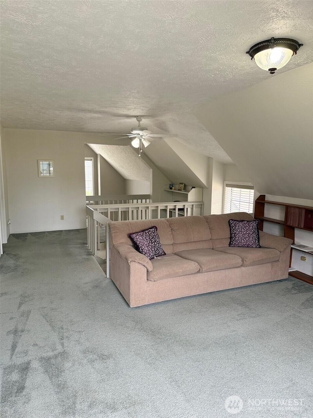 598 Blue Wing Loop SE, Ocean Shores, WA 98569 - living area with a textured ceiling, carpet flooring, vaulted ceiling, and ceiling fan
