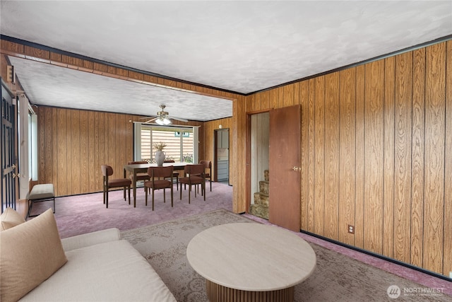 2507 Bay Ave, Hoquiam, WA 98550 - carpeted living room with ceiling fan and wooden walls