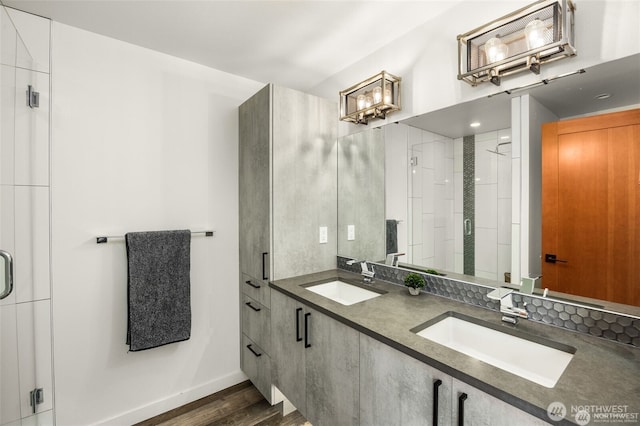 917 NW 51st St Unit D, Seattle, WA 98107 - bathroom with a shower stall, double vanity, and wood finished floors