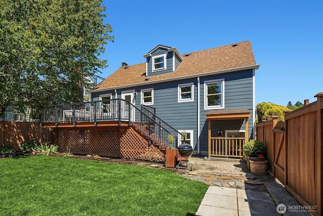 3033 48th Ave SW, Seattle, WA 98116 - back of property with a fenced backyard, a deck, stairs, and roof with shingles