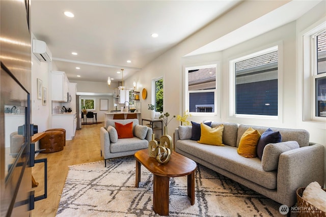 5310 46th Ave S, Seattle, WA 98118 - living room featuring a wall mounted AC, recessed lighting, light wood-type flooring, and a chandelier